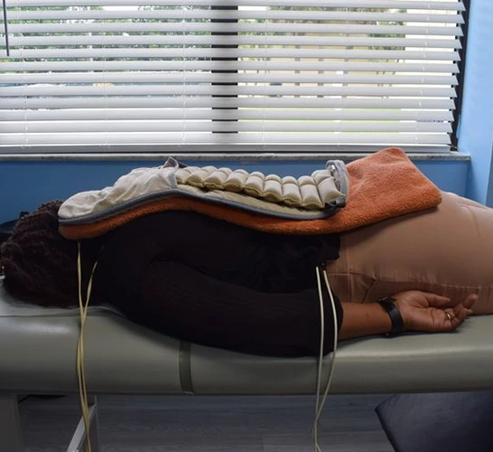 Patient receiving treatment on therapy table