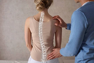 Chiropractor adjusting patient's spine alignment