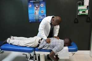 Chiropractor treating patient on table.