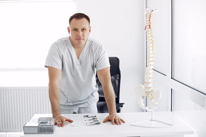 Doctor with spinal model, discussing advanced non-surgical spinal decompression.