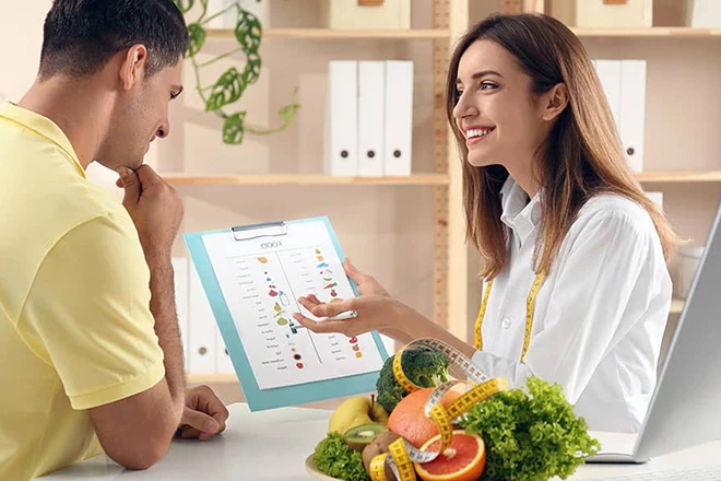 Chiropractor providing nutrition counseling to a patient.